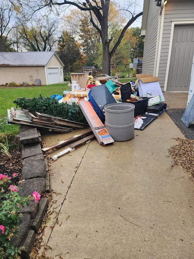 Dumpster being loaded with debris for Estate Cleanout Dumpster Rental in Dumbarton